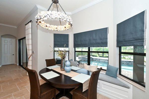5507 Arnie Loop Lakewood Ranch, FL 34211 - Photo 14 of 68 a view of a dining room with furniture wooden floor and chandelier
