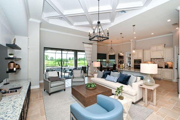 5507 Arnie Loop Lakewood Ranch, FL 34211 - Photo 15 of 68 a living room with furniture kitchen view and a chandelier