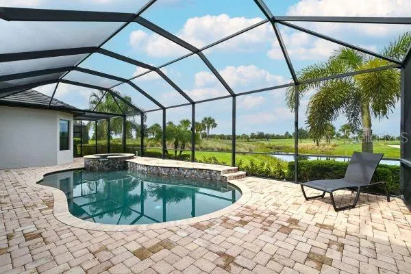 a house with swimming pool in front of it