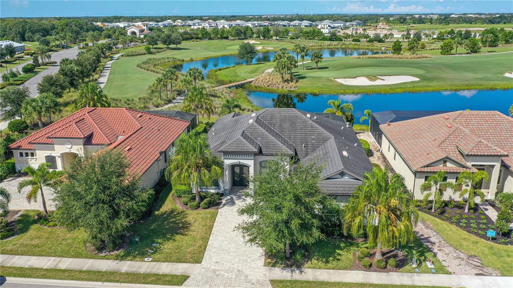 5507 Arnie Loop Lakewood Ranch, FL 34211 - Photo 61 of 68 an aerial view of a house with a garden and lake view