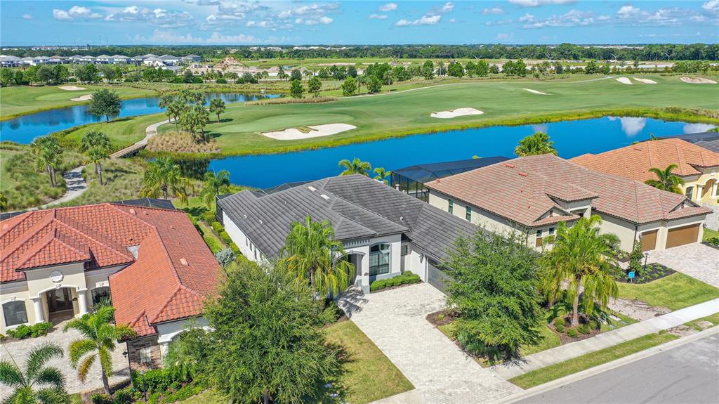 5507 Arnie Loop Lakewood Ranch, FL 34211 - Photo 62 of 68 an aerial view of a house with a garden and lake view