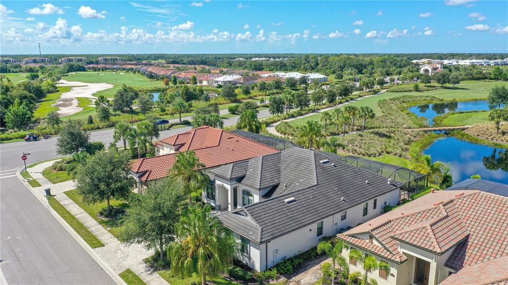 5507 Arnie Loop Lakewood Ranch, FL 34211 - Photo 63 of 68 an aerial view of a house with a garden and lake view