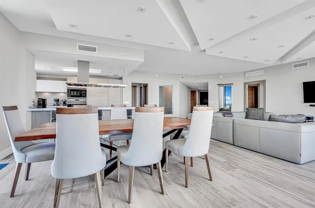 a view of a hallway view with wooden floor and a large window