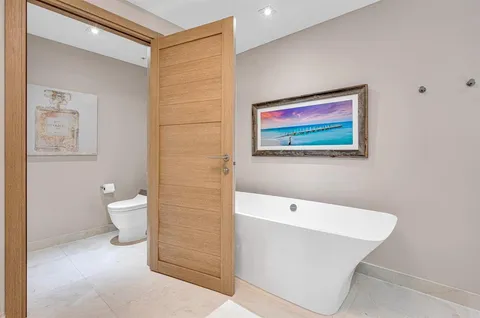 a dining room with furniture a chandelier and wooden floor