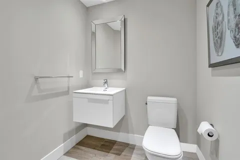 a dining room with furniture a chandelier and wooden floor