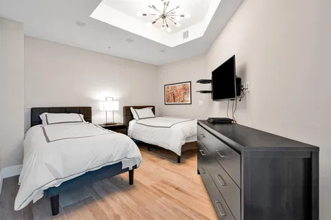 a bedroom with two beds and a night stand