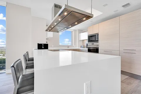 a view of a hallway with wooden floor and closet