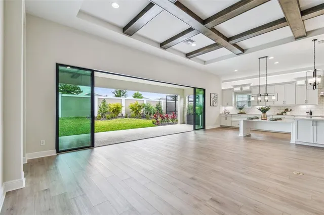 a large kitchen with kitchen island lots of counter space a sink and stainless steel appliances
