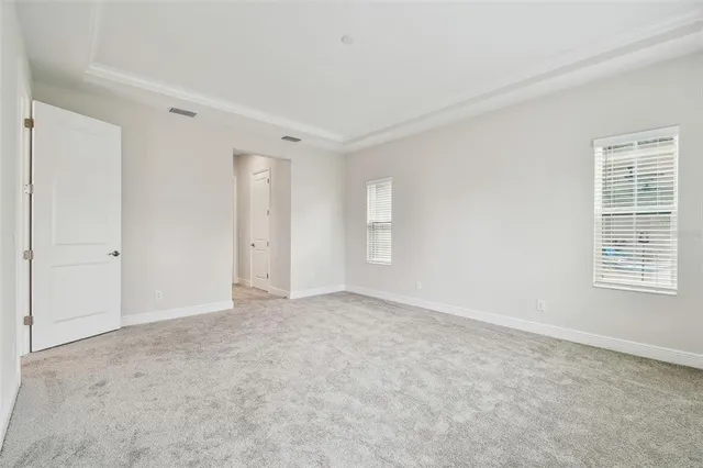 an empty room with wooden floor a ceiling fan and closet