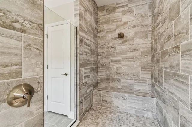 a bathroom with a sink a mirror and a shower