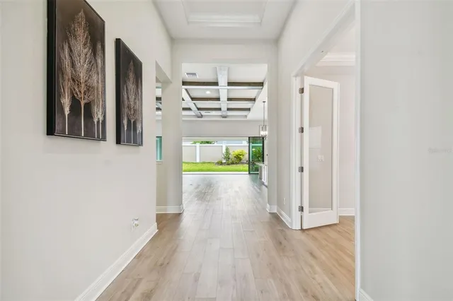 a view of an empty room with a fireplace and wooden floor