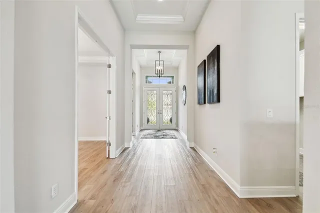 a view of a livingroom with wooden floor and a ceiling fan