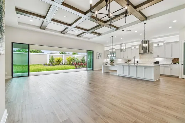 a kitchen with a table chairs and white cabinets