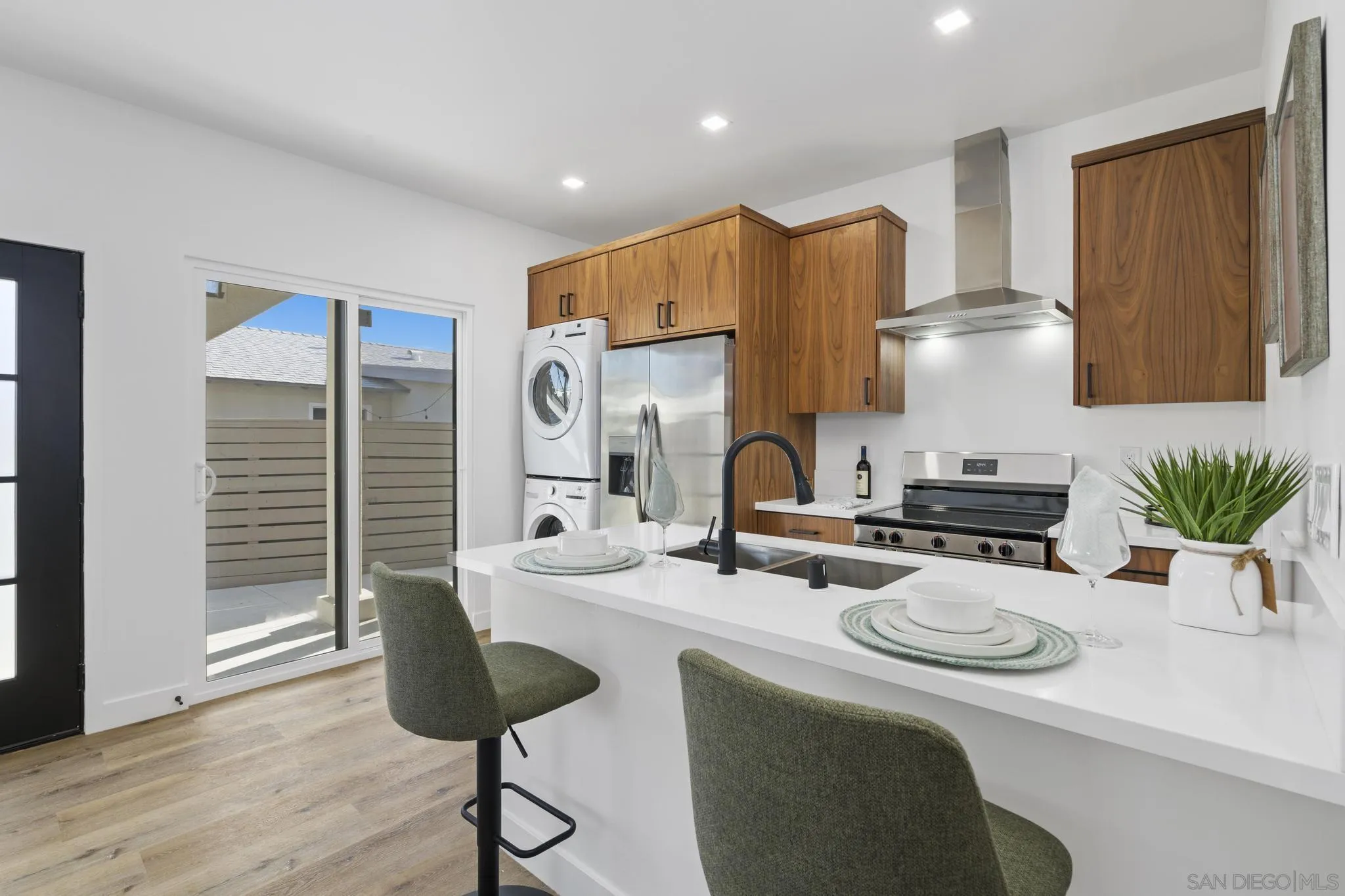 3582 Hatteras Avenue San Diego, CA 92117 - Photo 14 of 33 a kitchen with stainless steel appliances granite countertop a sink and a refrigerator