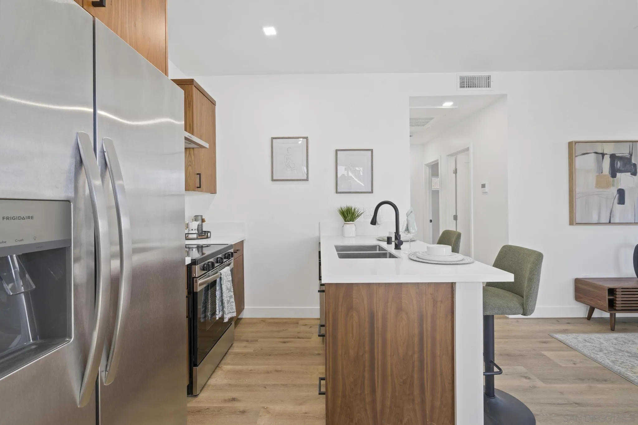 3582 Hatteras Avenue San Diego, CA 92117 - Photo 15 of 33 a kitchen with stainless steel appliances granite countertop a sink a stove and refrigerator
