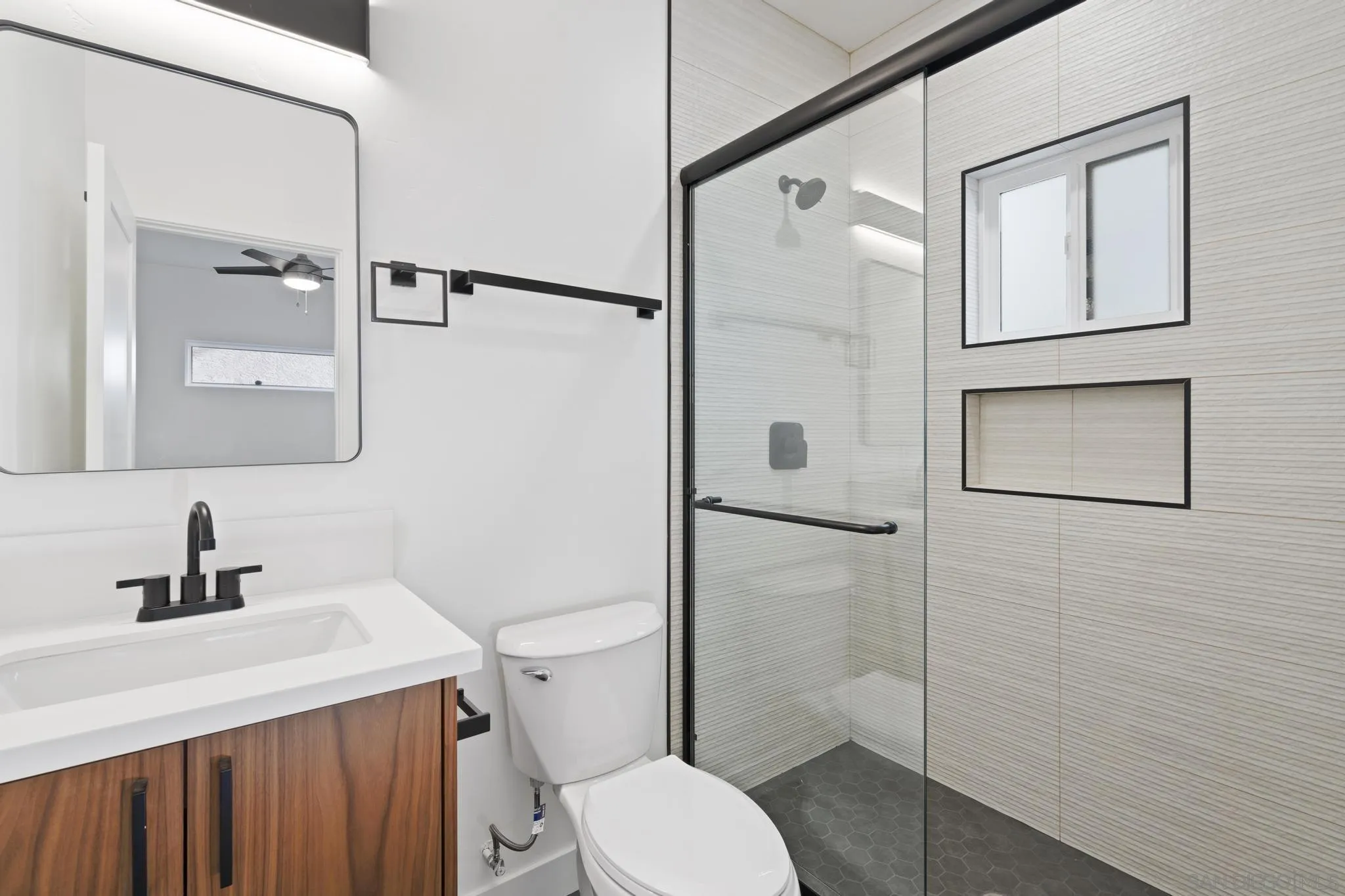 3582 Hatteras Avenue San Diego, CA 92117 - Photo 19 of 33 a bathroom with a toilet a sink and shower