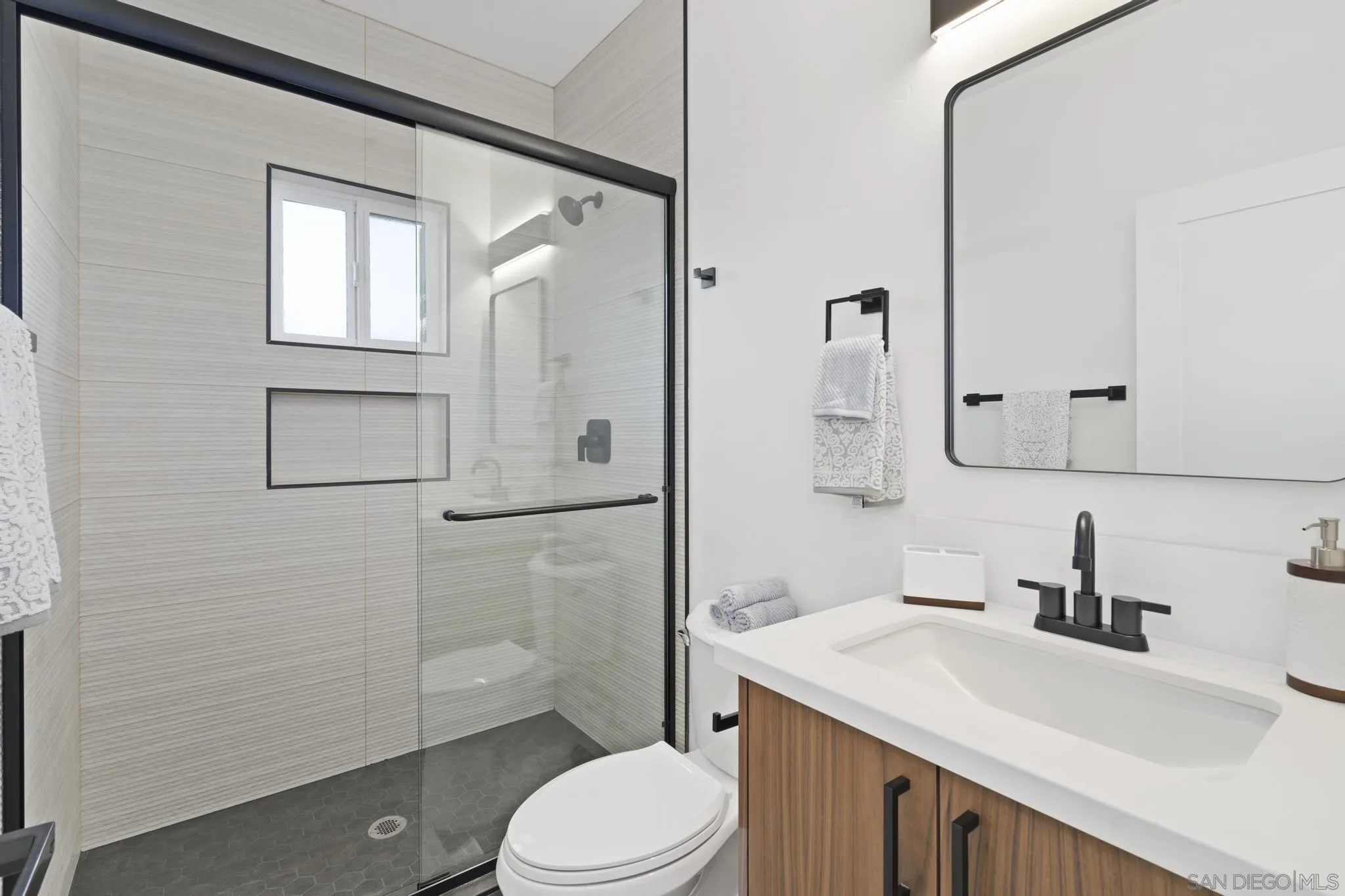 3582 Hatteras Avenue San Diego, CA 92117 - Photo 22 of 33 a bathroom with a sink a toilet and shower