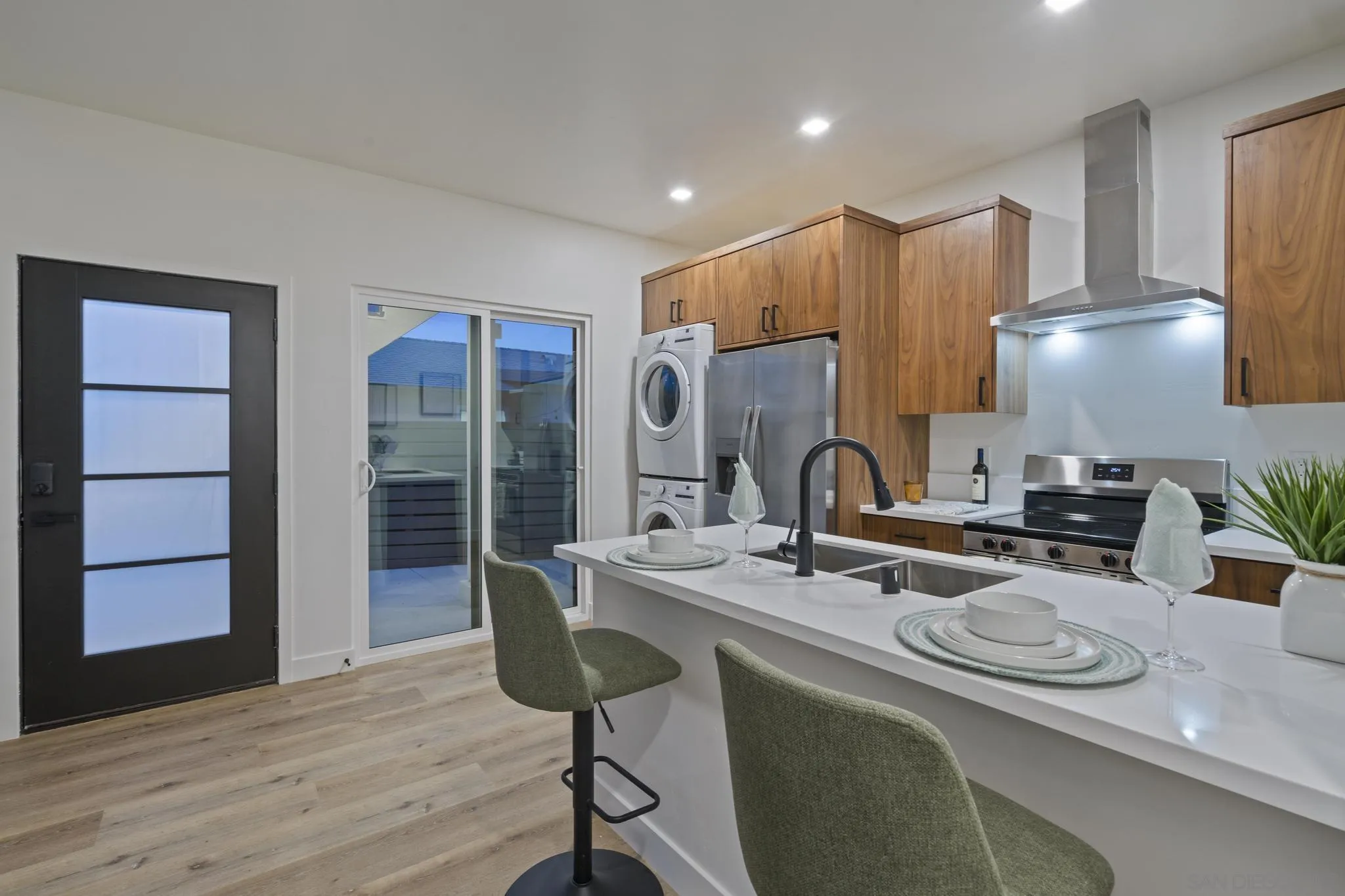 3582 Hatteras Avenue San Diego, CA 92117 - Photo 9 of 33 a kitchen with stainless steel appliances granite countertop a sink refrigerator and cabinets