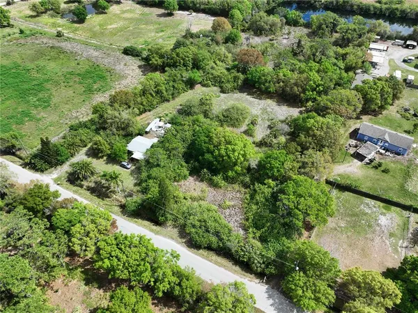 an aerial view of a houses with yard