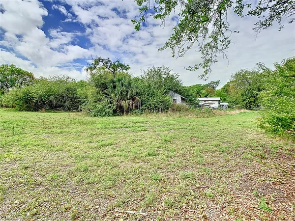 a backyard of a house with lots of green space