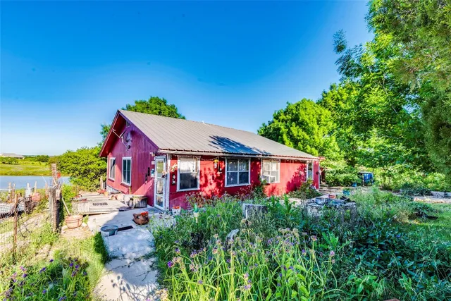 an aerial view of a house with swimming pool garden and patio