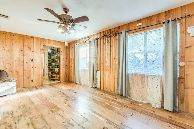 a view of a livingroom with a ceiling fan and window