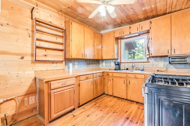 a kitchen with stainless steel appliances granite countertop a sink and cabinets