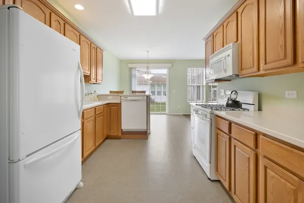a kitchen with cabinets and wooden floor