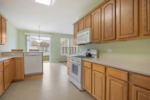 a kitchen with stainless steel appliances granite countertop a stove a sink dishwasher and a refrigerator