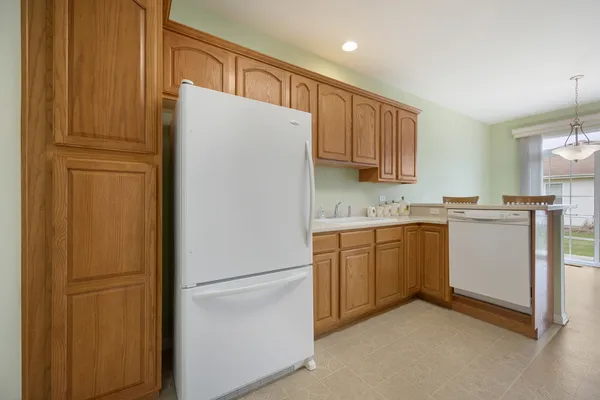 a white refrigerator freezer sitting in a kitchen