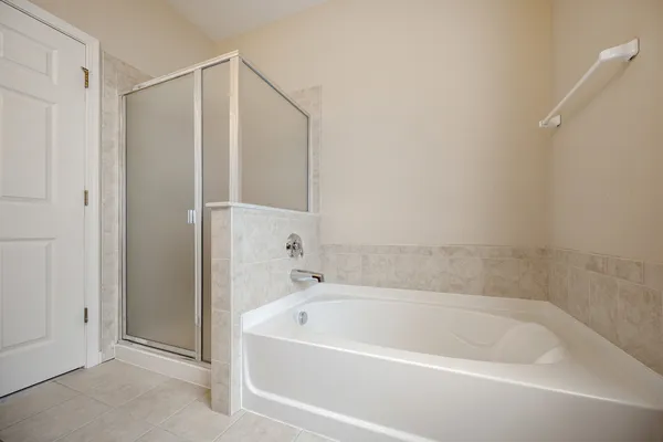 a bathroom with a bathtub and a shower