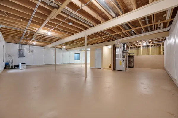 a view of water heater room with refrigerator