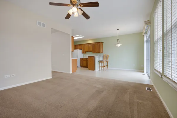 a view of a livingroom with a ceiling fan and window