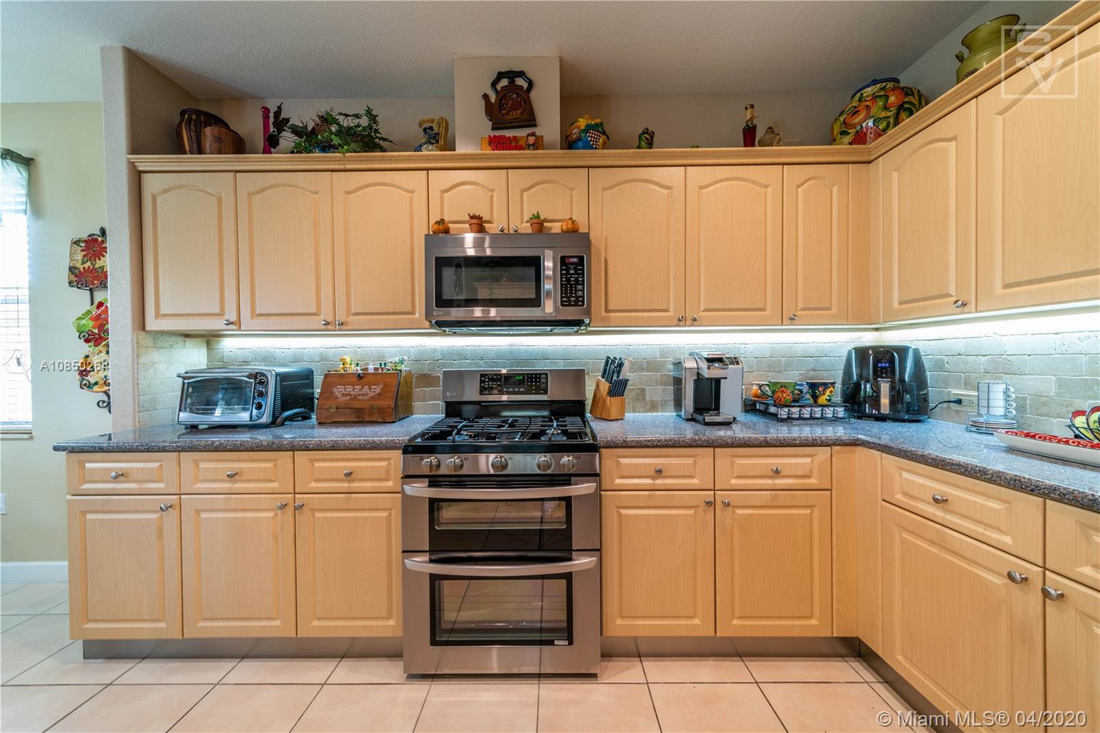 14933 Southwest 22 Street Miami, FL 33185 - Photo 23 of 49 Open Kitchen w/ upgraded backsplash and countertops