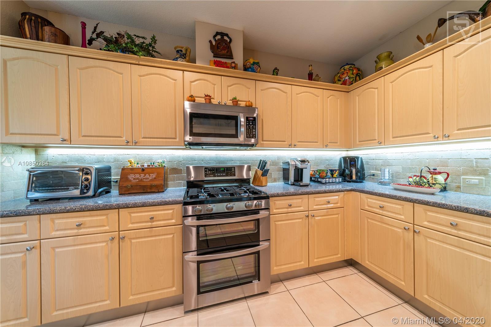 14933 Southwest 22 Street Miami, FL 33185 - Photo 24 of 49 Open Kitchen w/ upgraded backsplash and countertops