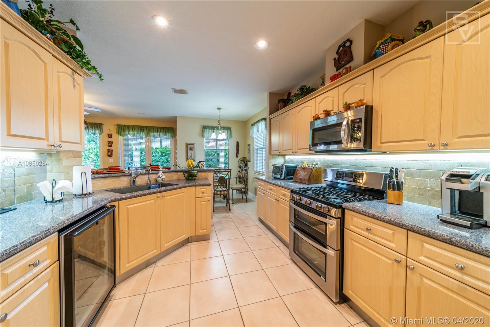 14933 Southwest 22 Street Miami, FL 33185 - Photo 25 of 49 Open Kitchen w/ upgraded backsplash and countertops