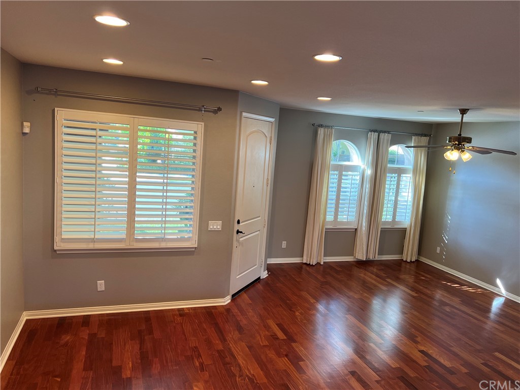 52 Shadowplay Irvine, CA 92620 - Photo 2 of 18 a view of an empty room with wooden floor and a window