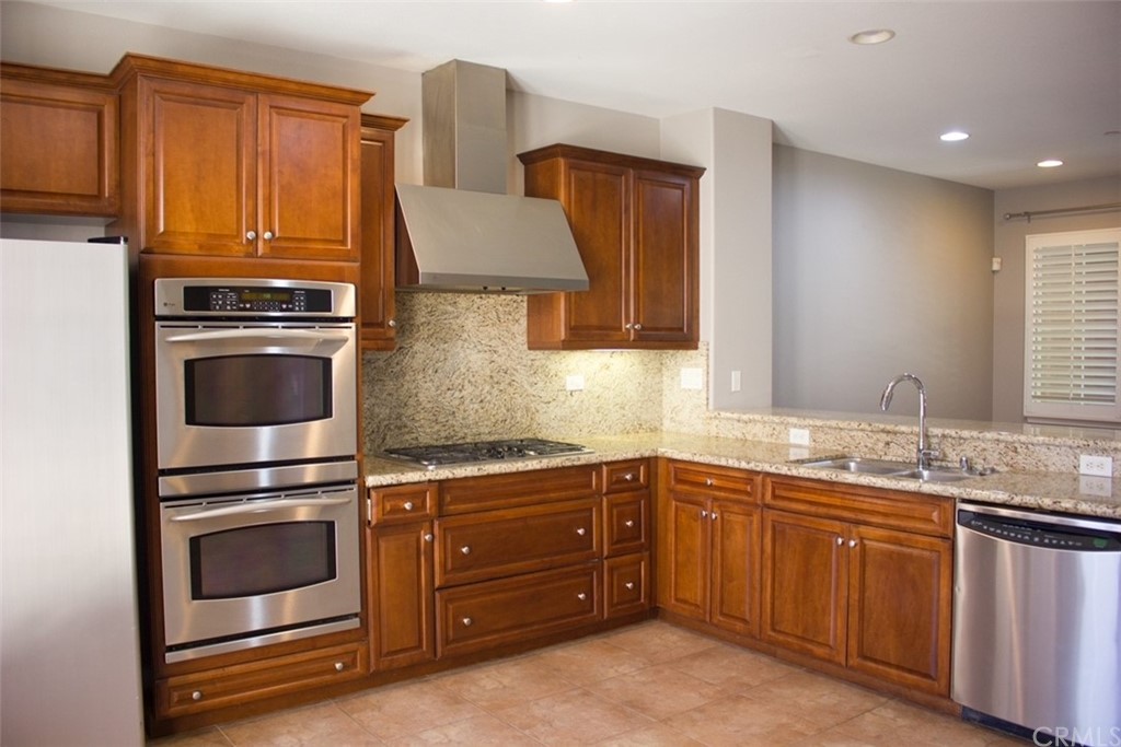 52 Shadowplay Irvine, CA 92620 - Photo 5 of 18 a kitchen with a sink and a stove top oven