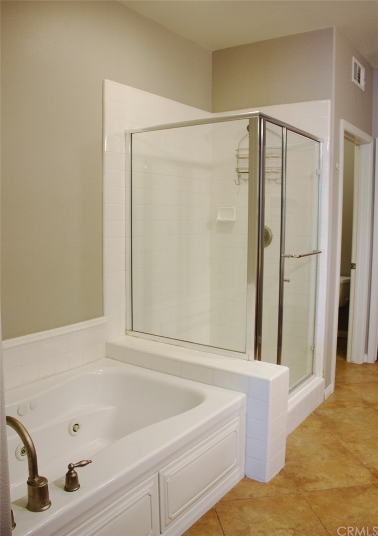 52 Shadowplay Irvine, CA 92620 - Photo 8 of 18 a bathroom with a bathtub and a shower