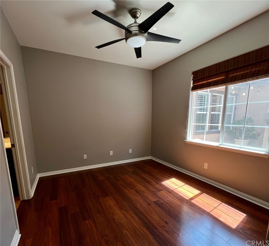 52 Shadowplay Irvine, CA 92620 - Photo 9 of 18 an empty room with wooden floor and windows