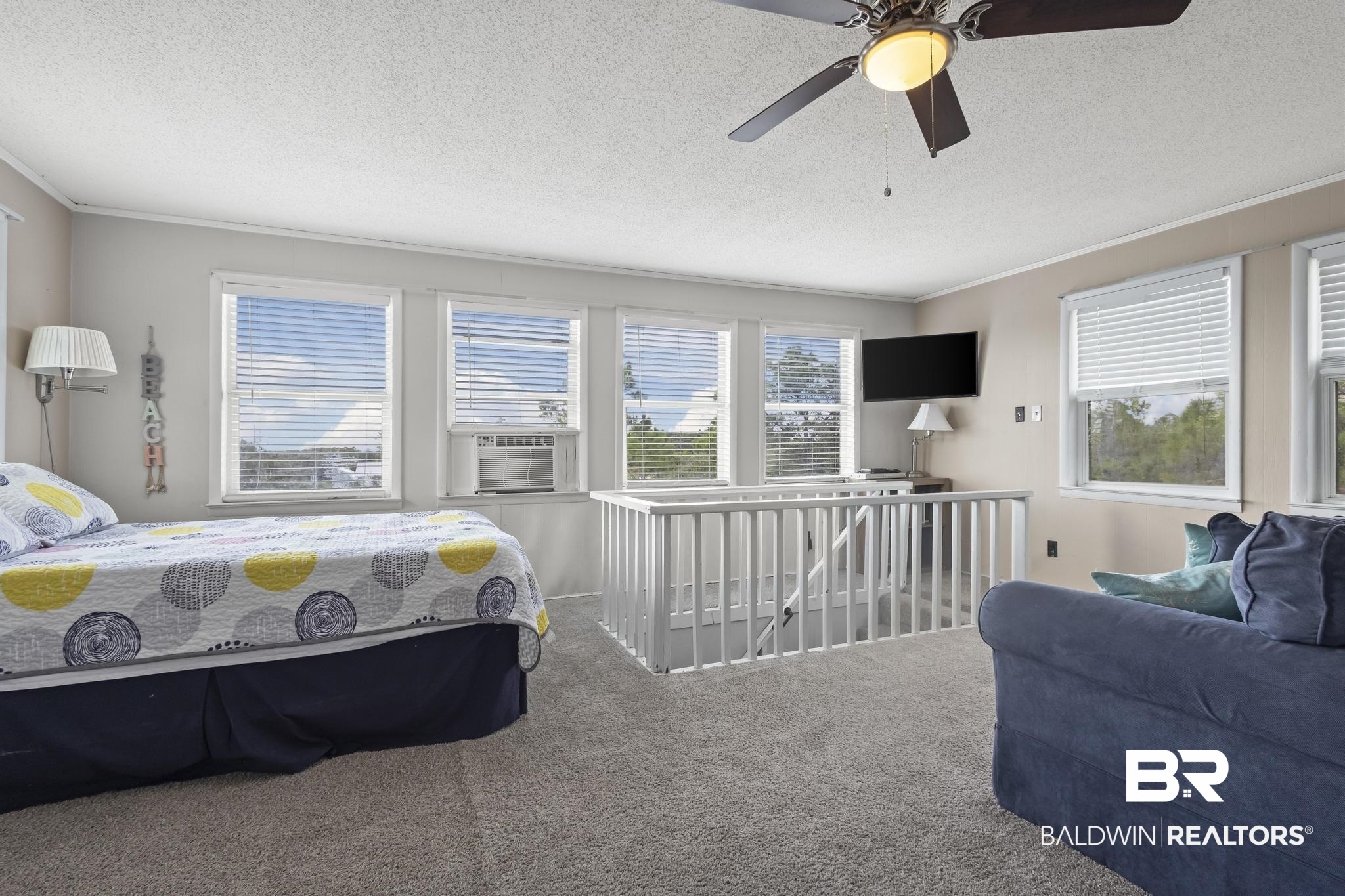 562 Veterans Road Gulf Shores, AL 36542 - Photo 26 of 32 Carpeted bedroom with crown molding, cooling unit, a textured ceiling, and a ceiling fan