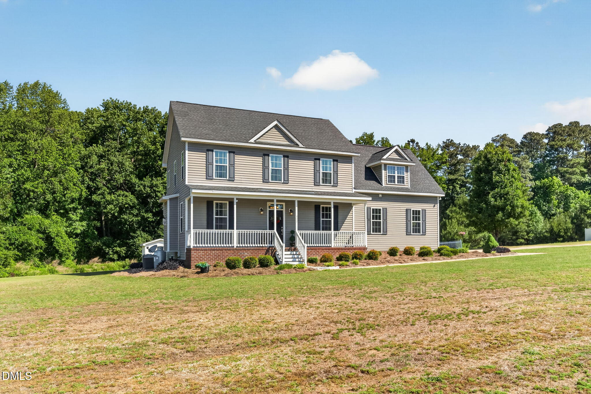 923 White Memorial Church Road Willow Spring, NC 27592 - Photo 4 of 46 a front view of a house with a yard table and chairs