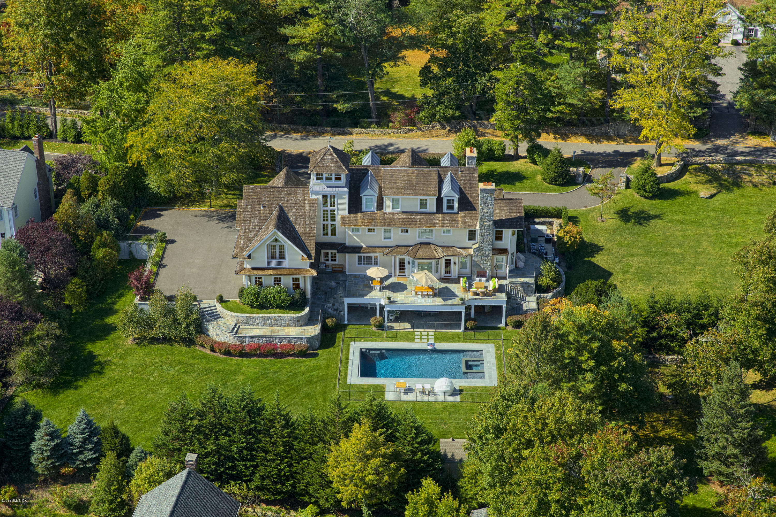 an aerial view of a house with garden space and lake view