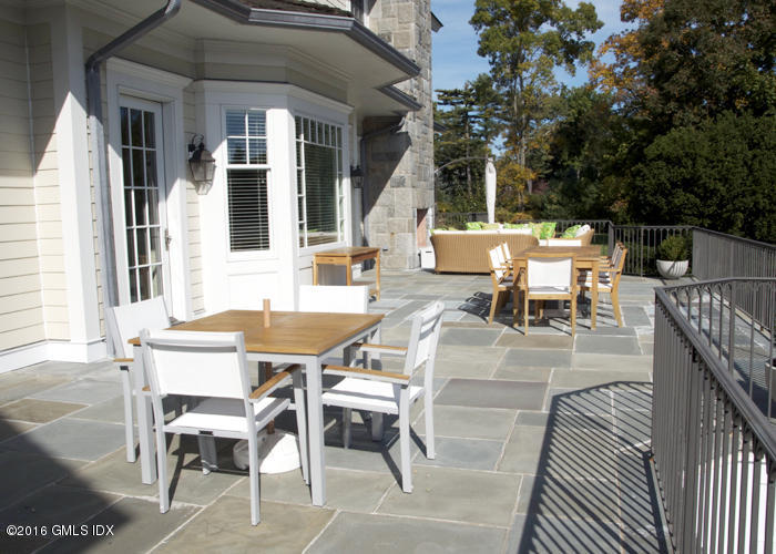 123 Doubling Road Greenwich, CT 06830 - Photo 16 of 31 a view of a patio with table and chairs with wooden floor and fence