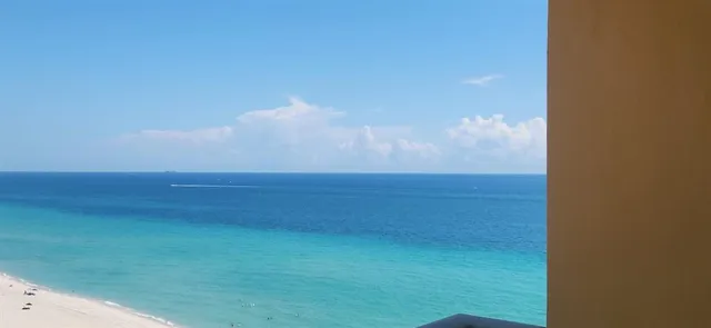 a view of a room with an empty space and a window