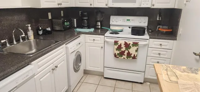 a kitchen with stainless steel appliances granite countertop a sink and a stove
