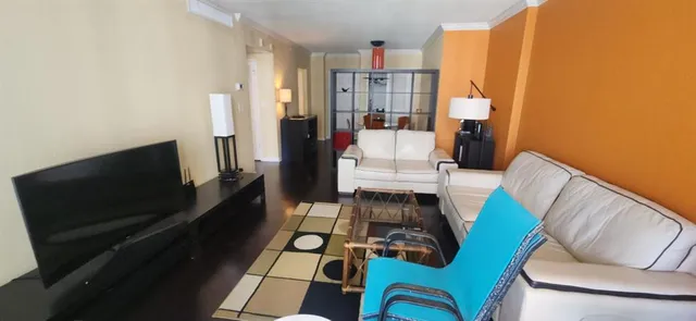 a living room with furniture and a rug