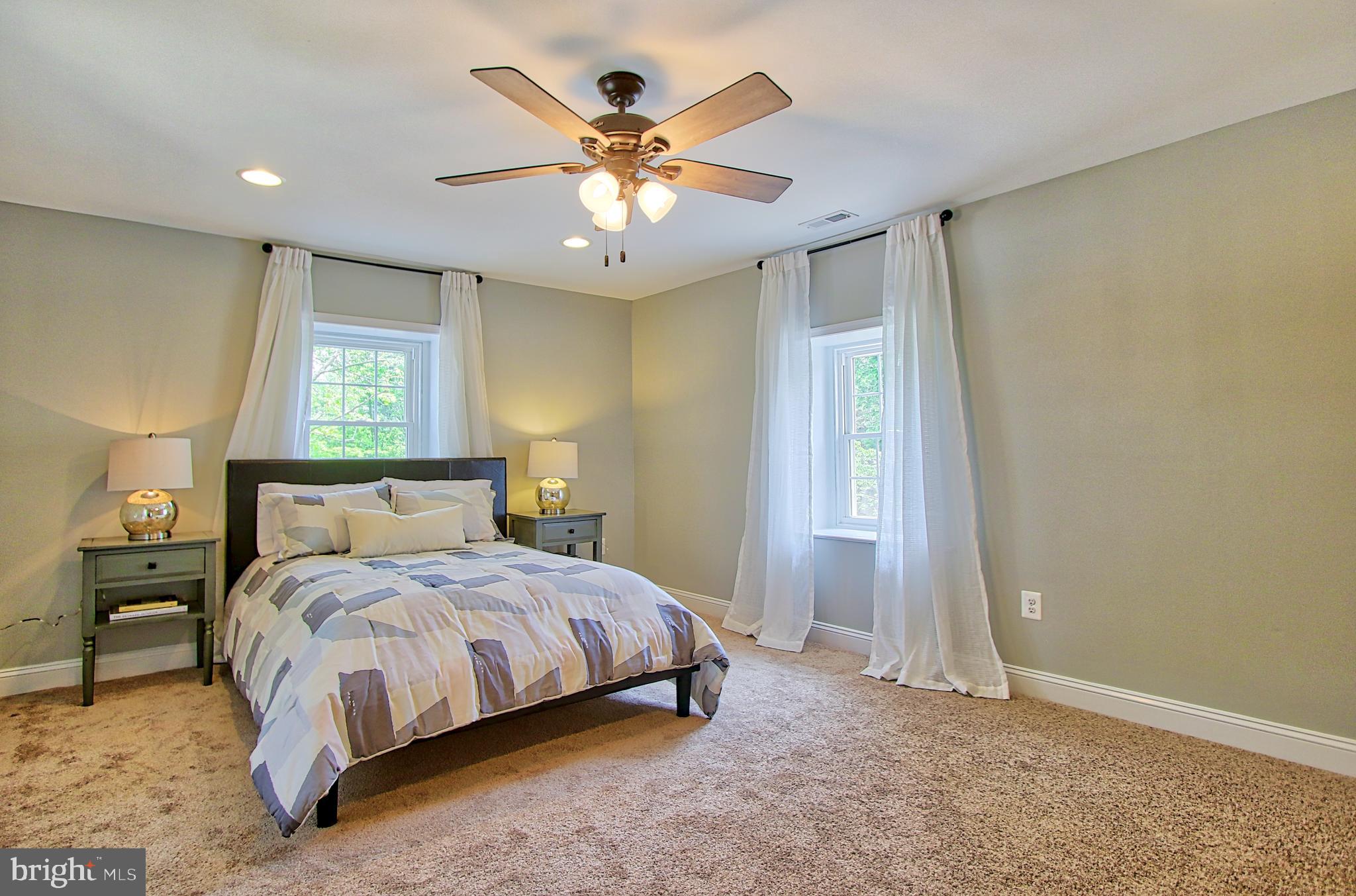 301 West Cold Spring Lane Baltimore, MD 21210 - Photo 20 of 38 a bedroom with a bed and a chandelier