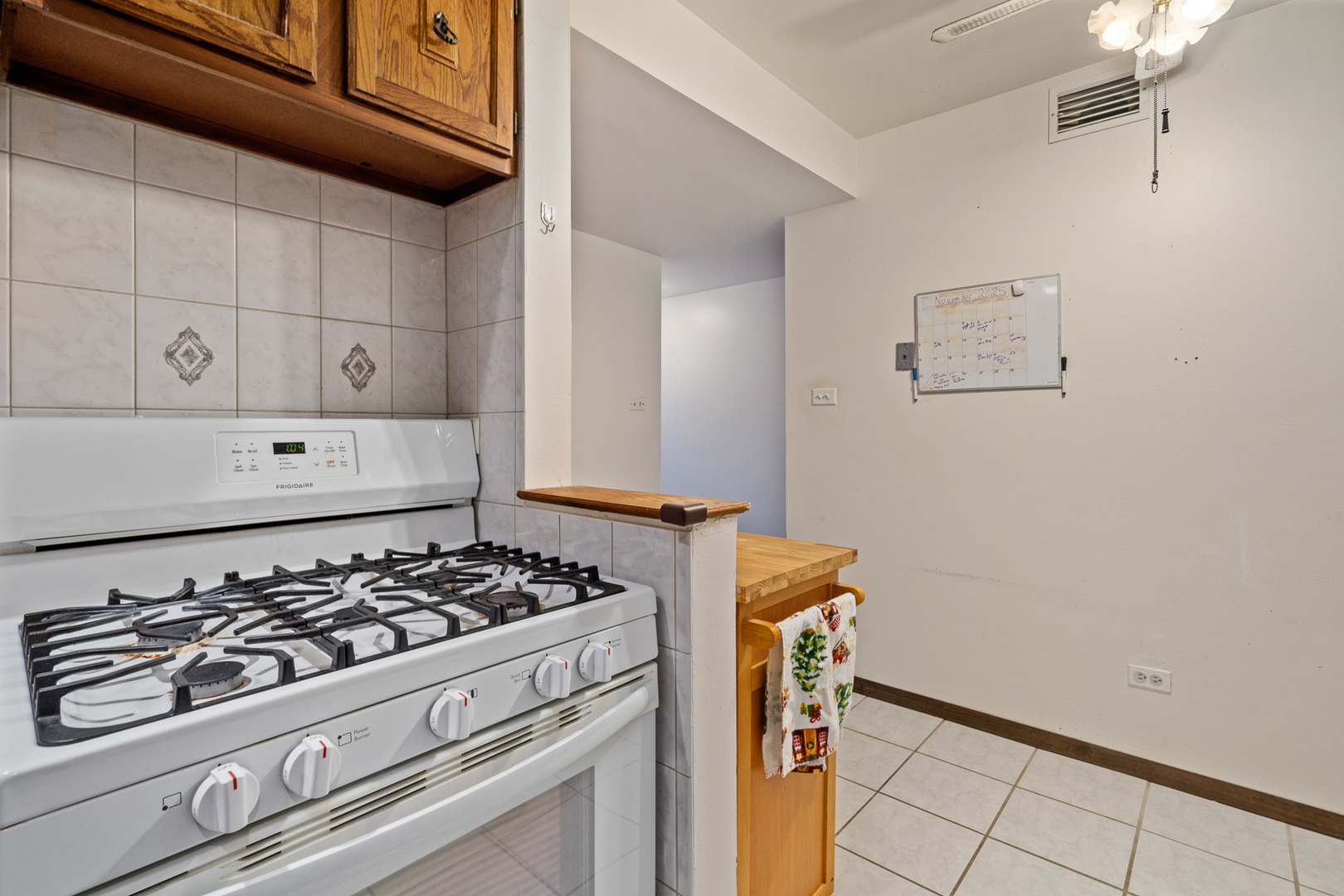 13615 Lavergne Avenue, Unit 110 Crestwood, IL 60418 - Photo 8 of 36 a kitchen with a stove and white cabinets