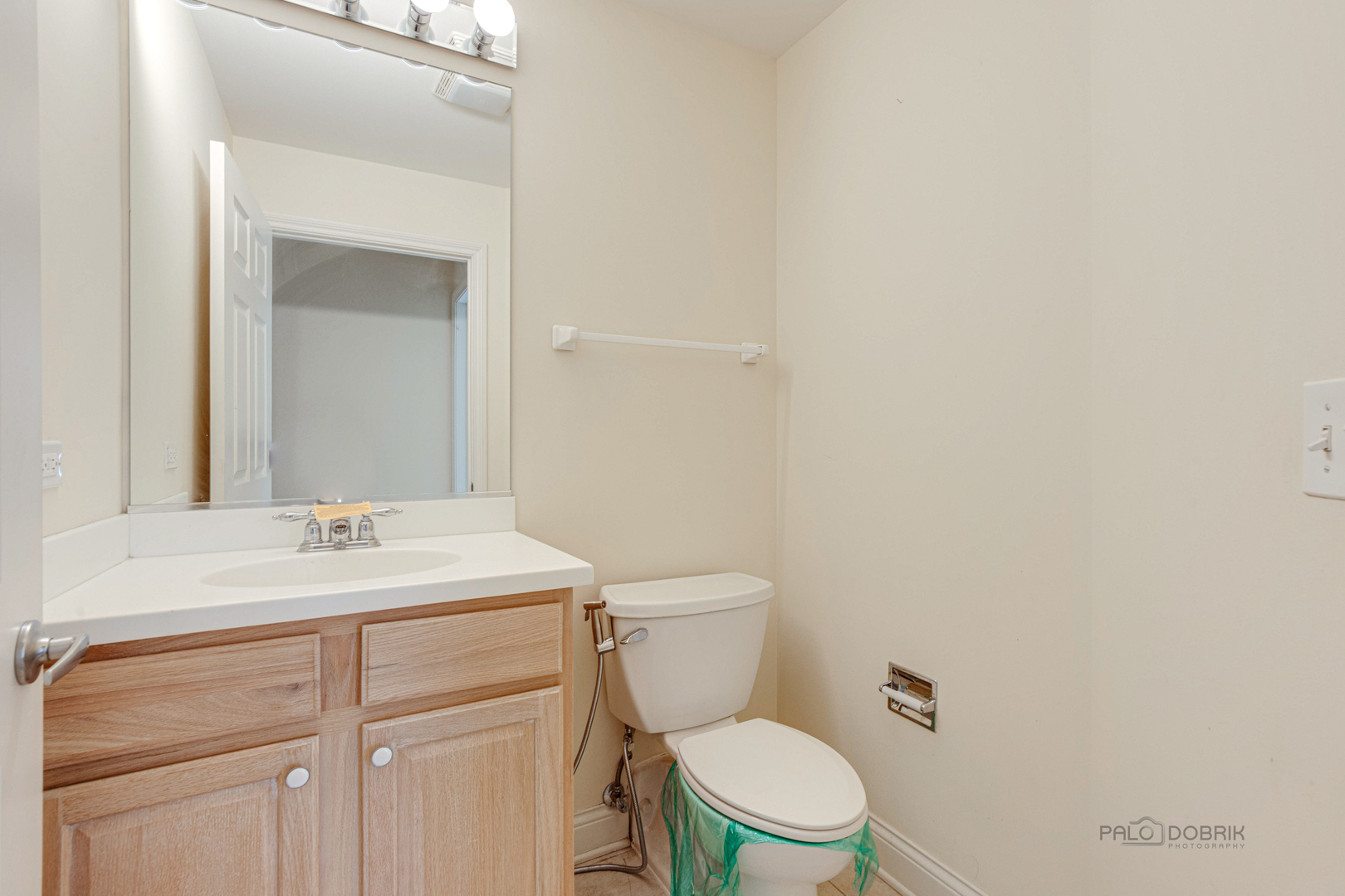2700 Summit Drive, Unit 209 Glenview, IL 60025 - Photo 15 of 23 a bathroom with a sink a toilet and a mirror
